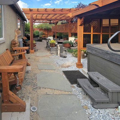 Custom Adirondack Chain Glider (Options: 3-Person, California Redwood, Classic Swing Bench Seat by Custom Request, Transparent Premium Sealant). Photo Also Shows a Traditional Garden Pergola and a Hot Tub Pavilion. Photo Taken 1 Year After Installation. Photo Courtesy of N. Moreau of Reno, NV.