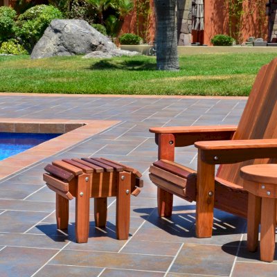 Adirondack Wooden Folding Chair (Options: Old-Growth Redwood, No Cushions, Add Flat Ottoman, Transparent Premium Sealant). Photo also shows Round Side Table.