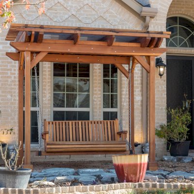 Angel's Trellis Swing (Options: 9' x 6', California Redwood, with Rain Guard, Classic Design Seat, 7.5' Posts by Custom Request, Post Anchoring for Concrete, Transparent Premium Sealant). Photo Courtesy of C. Edwards of Fort Worth, TX.