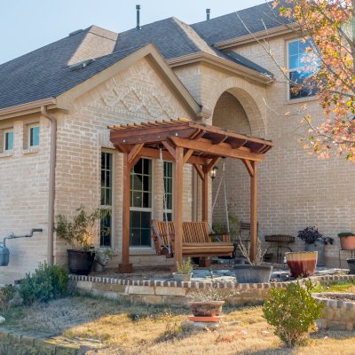 Angel's Trellis Swing (Options: 9' x 6', California Redwood, with Rain Guard, Classic Design Seat, 7.5' Posts by Custom Request, Post Anchoring for Concrete, Transparent Premium Sealant). Photo Courtesy of C. Edwards of Fort Worth, TX.