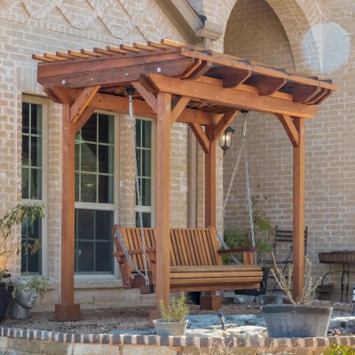 Angel's Trellis Swing (Options: 9' x 6', California Redwood, with Rain Guard, Classic Design Seat, 7.5' Posts by Custom Request, Post Anchoring for Concrete, Transparent Premium Sealant). Photo Courtesy of C. Edwards of Fort Worth, TX.