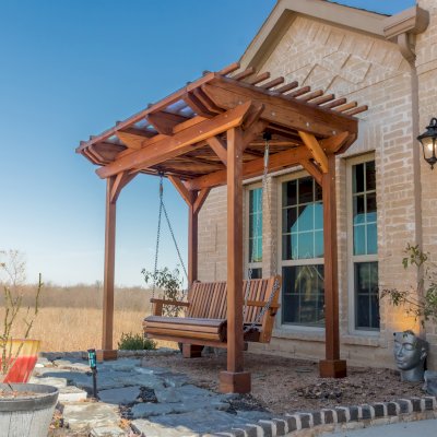 Angel's Trellis Swing (Options: 9' x 6', California Redwood, with Rain Guard, Classic Design Seat, 7.5' Posts by Custom Request, Post Anchoring for Concrete, Transparent Premium Sealant). Photo Courtesy of C. Edwards of Fort Worth, TX.