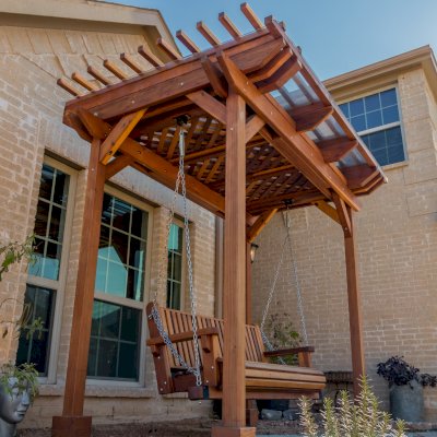 Angel's Trellis Swing (Options: 9' x 6', California Redwood, with Rain Guard, Classic Design Seat, 7.5' Posts by Custom Request, Post Anchoring for Concrete, Transparent Premium Sealant). Photo Courtesy of C. Edwards of Fort Worth, TX.