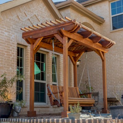 Angel's Trellis Swing (Options: 9' x 6', California Redwood, with Rain Guard, Classic Design Seat, 7.5' Posts by Custom Request, Post Anchoring for Concrete, Transparent Premium Sealant). Photo Courtesy of C. Edwards of Fort Worth, TX.