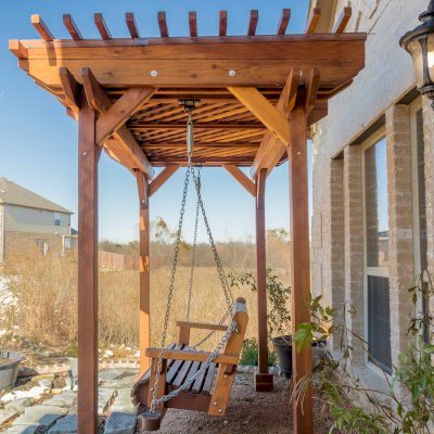 Angel's Trellis Swing (Options: 9' x 6', California Redwood, with Rain Guard, Classic Design Seat, 7.5' Posts by Custom Request, Post Anchoring for Concrete, Transparent Premium Sealant). Photo Courtesy of C. Edwards of Fort Worth, TX.