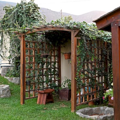 Arched Garden Arbor (Options: 48" W x 60" D, Mosaic Redwood, No Anchor Kit, Transparent Premium Sealant). Photo Also Shows a Sanctuary Patio Bench. Photos taken after 4 years of installation. 