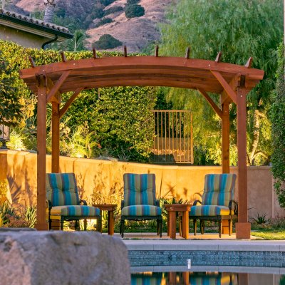 Arched Open Sky PergolaArched Open Sky Pergolas (Options: 11' L x 13' Arc W, Mature Redwood, Unattached, No Electrical Wiring Trim, 4-Post Anchor Kit for Concrete, No Ceiling Fan Base, No Privacy Panels, No Curtain Rods, 9' Post Height, Transparent Premium Sealant). Photo courtesy of G. Gigante of Glendora, CA.