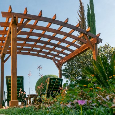 Arched Open Sky PergolaArched Open Sky Pergolas (Options: 11' L x 13' Arc W, Mature Redwood, Unattached, No Electrical Wiring Trim, 4-Post Anchor Kit for Concrete, No Ceiling Fan Base, No Privacy Panels, No Curtain Rods, 9' Post Height, Transparent Premium Sealant). Photo courtesy of G. Gigante of Glendora, CA.