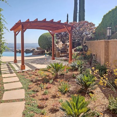 Arched Open Sky Pergolas (Options: 11' L x 13' Arc W, Mature Redwood, Unattached, No Electrical Wiring Trim, 4-Post Anchor Kit for Concrete, No Ceiling Fan Base, No Privacy Panels, No Curtain Rods, 9' Post Height, Transparent Premium Sealant). Photo courtesy of G. Gigante of Glendora, CA.