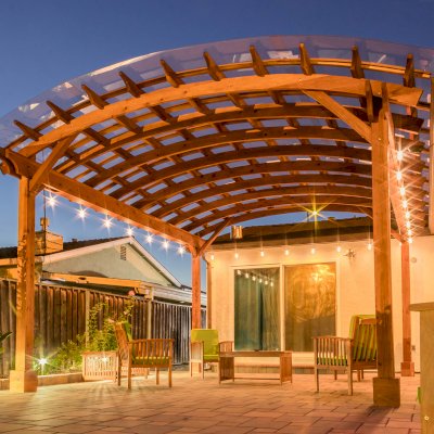 Arched Open Sky Pergolas (Options: 18' L x 16' Arc W, California Redwood, with Rain Guard, Electrical Wiring Trim for All Posts, 4-Post Anchor Kit for Concrete, No Ceiling Fan Base, No Privacy Panels, No Curtain Rods, 9.5' Post Height, Transparent Premium Sealant).