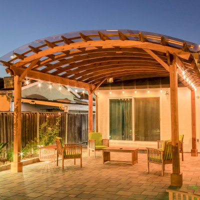 Arched Open Sky Pergolas (Options: 18' L x 16' Arc W, California Redwood, with Rain Guard, Electrical Wiring Trim for All Posts, 4-Post Anchor Kit for Concrete, No Ceiling Fan Base, No Privacy Panels, No Curtain Rods, 9.5' Post Height, Transparent Premium Sealant).