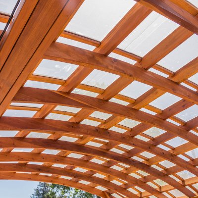 Arched Open Sky Pergolas (Options: 18' L x 16' Arc W, California Redwood, with Rain Guard, Electrical Wiring Trim for All Posts, 4-Post Anchor Kit for Concrete, No Ceiling Fan Base, No Privacy Panels, No Curtain Rods, 9.5' Post Height, Transparent Premium Sealant).