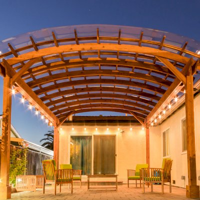 Arched Open Sky Pergolas (Options: 18' L x 16' Arc W, California Redwood, with Rain Guard, Electrical Wiring Trim for All Posts, 4-Post Anchor Kit for Concrete, No Ceiling Fan Base, No Privacy Panels, No Curtain Rods, 9.5' Post Height, Transparent Premium Sealant).