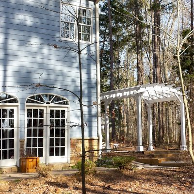 Arched Open Sky Pergolas (Options: 10' L x 12' Arc W, Douglas-fir, Unattached, No Electrical Wiring Trim, Arched Roof without Lattice Panels, 4-Post Anchor Kit for Stone, No Ceiling Fan Base, No Privacy Panels, No Curtain Rods, 9' Post Height, Off-White Oil-Based Primer). Photo courtesy of D. Bochnovic of Henderson, North Carolina.