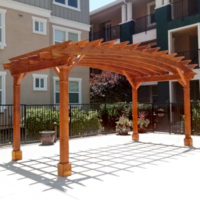 Arched Open Sky Pergolas (Options: 10' L x 20' Arc W, California Redwood, No Electrical Wiring Trim, Horizontal Decorative Trims on Posts, 4-Post Anchor Kit for Concrete, No Ceiling Fan Base, No Privacy Panels, No Curtain Rods, 9' Post Height, Transparent Premium Sealant). Photo Courtesy of M. Castaneda of Pleasanton, CA.
