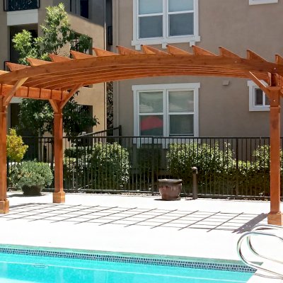 Arched Open Sky Pergolas (Options: 10' L x 20' Arc W, California Redwood, No Electrical Wiring Trim, Horizontal Decorative Trims on Posts, 4-Post Anchor Kit for Concrete, No Ceiling Fan Base, No Privacy Panels, No Curtain Rods, 9' Post Height, Transparent Premium Sealant). Photo Courtesy of M. Castaneda of Pleasanton, CA.