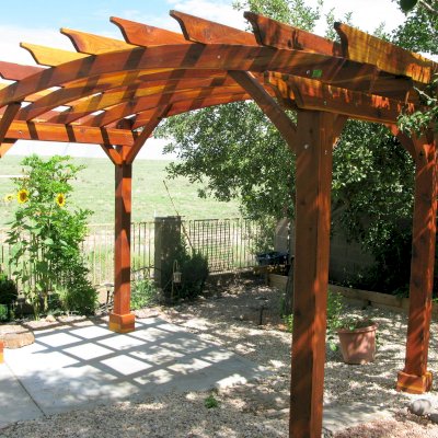 Arched Open Sky Pergolas (Custom Options: 8' L x 14' Arc W, California Redwood, Unattached, No Electrical Wiring Trim, Arched Roof without Lattice Panels, 4-Post Anchor kit for Stone, No Ceiling Fan Base, No Privacy Panels, No Curtain Rods, 10' Post Height, Transparent Premium Sealant). Photo Courtesy of Pat P. of Prescott Valley, Arizona.