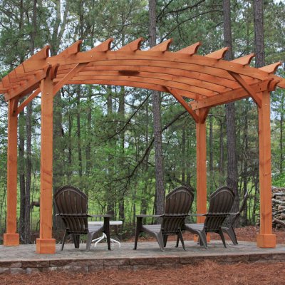 Arched Open Sky Pergolas (Options: 10' L x 14' Arc W, Mature Redwood, Unattached, No Electrical Wiring Trim, Arched Roof without Lattice Panels, 4-Post Anchor Kit for Stone, With Ceiling Fan Base, No Privacy Panels, No Curtain Rods, 9' Post Height, Transparent Premium Sealant). Photo Courtesy of Randall & Florence W. of Willow Spring, North Carolina.