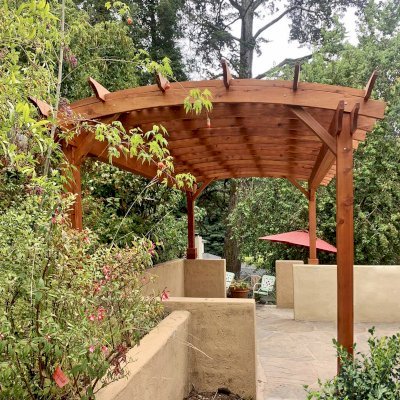 Arched Pergola Kit (Options: 20' L x 12' Arc W, Mature Redwood, No Electrical Wiring Trim Kits, 4-Post Anchor Kit for Concrete, No Ceiling Fan Bases, No Privacy Panels, No Curtain Rods, 9.5' Post Height, Transparent Premium Sealant). Photo Courtesy of L. Nelson of Oakland, CA.