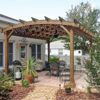 Arched Pergola Kits (Options: 18' L x 15' Arc W, California Redwood, No Electrical Wiring Trim, 4-Post Anchor Kit for Stone, Ceiling Fan Base, No Privacy Panels, No Curtain Rods, 9' Post Height, Transparent Premium Sealant). Here is how the same pergola looks after 3 years out in the Florida weather. Photo Courtesy of Bob Lilys of Central Florida. 