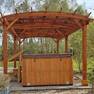 Arched Pergola Kit (Options: 22' L x 14' Arc W, California Redwood, Electrical Wiring Trim Kit for 2 Posts, 6-Post Anchor Kit for Concrete, 1 Ceiling Fan Base, No Privacy Panels, No Curtain Rods, 10' Post Height, Transparent Premium Sealant). Photo Courtesy of D. Lewis of Whiteville, North Carolina.