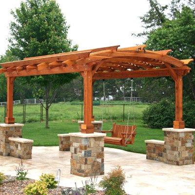 Arched Pergola Kits (Options: 16' L x 12' Arc W, California Redwood, Electrical Wiring Trim for 1 Post, 4-Post Anchor Kit for Concrete, No Ceiling Fan Base, No Privacy Panels, No Curtain Rods, 9' Post Height, Transparent Premium Sealant). With a Bench Swing by Custom Request. Photo Courtesy of Doug Kirkland of Valley Center, Kansas.