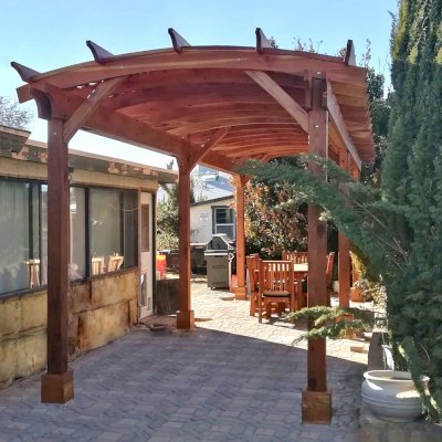 Arched Pergola Kit (Options: 30' L x 10' Arc W, California Redwood, 2 Electrical Wiring Trim Kits, 6-Post Anchor Kit for Concrete, No Ceiling Fan Bases, No Privacy Panels, No Curtain Rods, 9' Post Height, Transparent Premium Sealant). Photo Courtesy of J. Wangemann of Ridgecrest, CA.