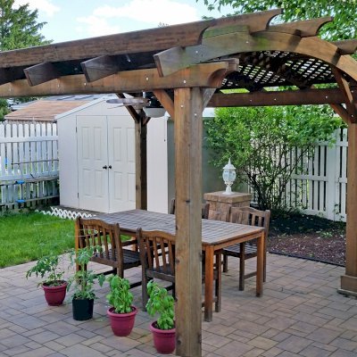 Arched Pergola Kit (Options: 14' L x 12' Arc W, California Redwood, No Electrical Wiring Trim Kit, 4-Post Anchor Kit for Concrete, No Ceiling Fan Base, No Privacy Panels, No Curtain Rods, 9' Post Height, Transparent Premium Sealant). Photo Courtesy of Joe Cario of Moonachie, New Jersey.