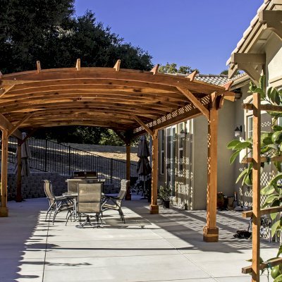 Arched Pergola Kit (Options: 39' L x 16' Arc W, California Redwood, Electrical Wiring Trim Kit for 2 Posts, 6-Post Anchor Kit for Concrete, 2 Ceiling Fan Bases, No Privacy Panels, No Curtain Rods, 9.5' Post Height, Transparent Premium Sealant). Photo Courtesy of S. Brunshwiler of Gilroy, CA,