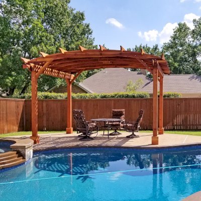 Arched Pergola Kit (Options: 12' L x 16' Arc W, California Redwood, Electrical Wiring Trim Kit for 1 Post, 4-Post Anchor Kit for Concrete, 1 Ceiling Fan Base, No Privacy Panels, No Curtain Rods, 9' Post Height, Transparent Premium Sealant). Photo Courtesy of Trudy & Dog Heatherly of Coppell, Texas. 