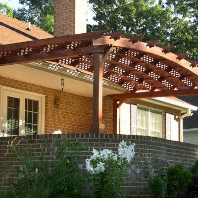 Arched Pergola Kits (Options: 10' L x 22' Arc W, Mature Redwood, No Electrical Wiring Trim, 4-Post Anchor kit for Stone, No Ceiling Fan Base, No Privacy Panels, No Curtain Rods, 9' Post Height (Front Posts Shorter by Custom Request), Cherry Stain Premium Sealant). Photo Courtesy of Josef M. of Fayetteville, Pennsylvania.