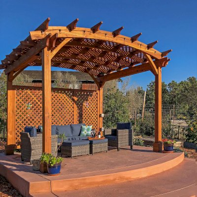 Arched Pergola Kits (Options: 12' L x 14' Arc W, Mature Redwood, 1 Electrical Wiring Trim, No Rain Guard, 4-Post Anchor Kit for Concrete, No Ceiling Fan Base, 1 Lattice Privacy Panels, No Curtain Rods, 9' Post Height, Transparent Premium Sealant). Photo Courtesy of J. Barlow of Soquel, CA.