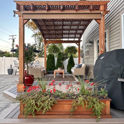 Arched Pergola Kits (Options: 10' L x 18' Arc W, Douglas-Fir, Electrical Wiring Trim for 2 Posts, Post Anchor Kit for High Wind, No Ceiling Fan Base, No Privacy Panels, No Curtain Rods, 10.5' Post Height, Transparent Premium Sealant). Photo Taken 1 Year After Installation. Photo Also Shows a Carmel Planter. Photo Courtesy of S. Bono of Royal Oak, MI.
