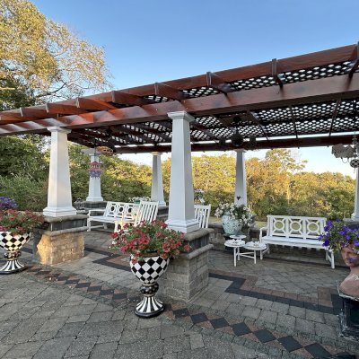 Arched Pergola Kit (Options: 27' L x 11.5' Arc W, Old-Growth Redwood, 1 Electrical Wiring Trim, Post Anchor Kit for Stone, 2 Ceiling Fan Base, No Privacy Panels, No Curtain Rods, 9' Post Height, Posts Surrounded with Fiber Glass Columns, 18" Overhangs Instead of the Standard 12", Transparent Premium Sealant). Photo Taken 9 Years After Installation. Photo Courtesy of E. Jowett of Cambridge, OH.