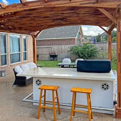 Arched Pergola Kit. (Options: 14' L x 16' Arc W, Mosaic Redwood, Electrical Wiring Trim Kit for 1 Post, with a Ceiling Fan Base, Transparent Premium Sealant). Photo Courtesy of E. Buffamante of Richmond, TX.