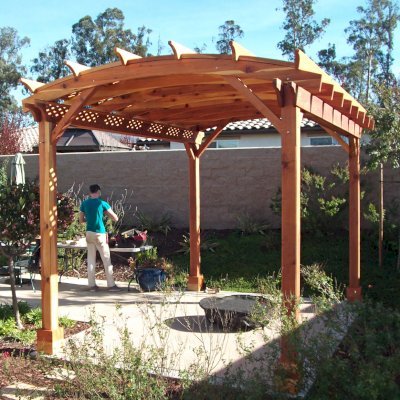 Arched Pergola Kit. (Options: 16' L x 12' Arc W, California Redwood, No Electrical Wiring Trims, 4-Post Anchor Kit for Concrete, No Ceiling Fan Base, No Privacy Panels, No Curtain Rods, 6" Overhangs on Supports Side by Custom Request, Transparent Premium Sealant). Photo Courtesy of Fred Swendson.