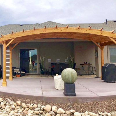 Arched Pergola Kit (Options: 10' L x 24' Arc W, Douglas-fir, No Electrical Wiring Trim, 4-Post Anchor Kit for Concrete, No Ceiling Fan Base, No Privacy Panels, No Curtain Rods, 9' Post Height, Transparent Premium Sealant). Photo Courtesy of H. Dolan of Prescott, AZ.
