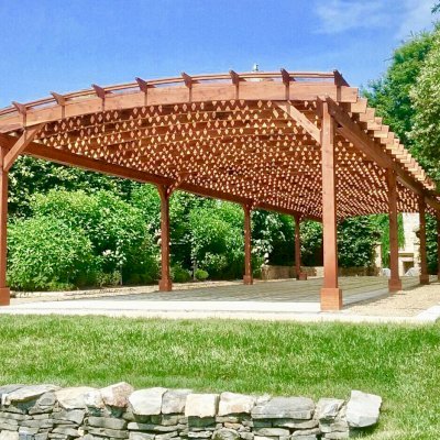 Arched Pergola Kit (Options: 74' L x 18.5' Arc W, Mature Redwood, with Rainguard, Electrical Wiring Trim for 1 Post, 10-Post Anchor Kit for Concrete, 2 Ceiling Fan Bases, No Privacy Panels, No Curtain Rods, 9' Post Height, Transparent Premium Sealant). Photo Courtesy of H. Mitchell of The Plains, VA.