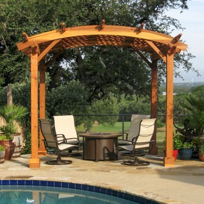 Arched Pergola Kits (Options: 12' x 10' Arc W, California Redwood, No Electrical Wiring Trim, 4-Post Anchor Kit for Stone, No Ceiling Fan Base, No Privacy Panels, No Curtain Rods, 9' Post Height, Transparent Premium Sealant). Photo Courtesy of Mr John & Vicky Lewis of Wimberley, TX.