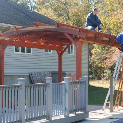 Arched Pergola Kits (Options: 16' L x 12' Arc W, California Redwood, No Electrical Wiring Trim, 4-Post Anchor Kit for Stone, Ceiling Fan Base, No Privacy Panels, No Curtain Rods, 9' Post Height, Transparent Premium Sealant). Photo Courtesy of Mr John & Virginia Mitchell of Greenwood, Delaware.