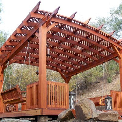 Arched Pergola Kits (Options: 18' x 18', Mature Redwood, 3 Degree Roof Slope by Custom Request, with Deck and Railing by Custom Request, with a Bench Swing Seat). Photo Also Shows a Custom Storage Bench. Photo Courtesy of Bob P. of Westlake Village, CA.