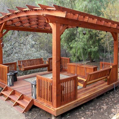 Arched Pergola Kits (Options: 18' x 18', Mature Redwood, 3 Degree Roof Slope by Custom Request, with Deck and Railing by Custom Request, with a Bench Swing Seat). Photo Also Shows a Custom Storage Bench. Photo Courtesy of Bob P. of Westlake Village, CA.