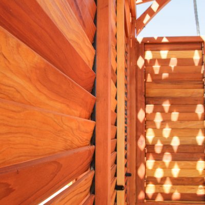 Arched Pergola Kits (Options: 16' L x 14' Arc W, California Redwood, No Electrical Wiring Trim, 4-Post Anchor Kit for Stone, No Ceiling Fan Base, Privacy Panels & Louvers, No Curtain Rods, 9' Post Height, Transparent Premium Sealant). Photo Courtesy of George Jackson of Commerce Township, Michigan.