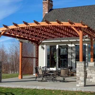 Arched Pergola Kits (Options: 20' L x 20' Arc W, California Redwood, No Electrical Wiring Trim, 6-Post Anchor Kit for High-Wind, No Ceiling Fan Base, 2 Privacy Panels, No Curtain Rods, with 6 Posts Instead of 4 by Custom Request, 9' Post Height, Transparent Premium Sealant). Photo Courtesy of Jessy Sirois of Hampden, Massachusetts.