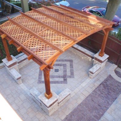 Arched Pergola Kits (Options: 12' L x 14' Arc W, California Redwood, No Electrical Witing Trim, 4-Post Anchor Kit for Stone, No Ceiling Fan Base, No Privacy Panels, No Curtain Rods, 9' Post Height, Transparent Premium Sealant). Photo Courtesy of Mr. Gary Benson of Depew, NY. Brick work done around posts after installation. 