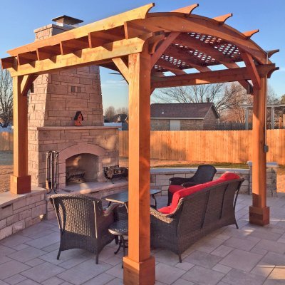 Arched Pergola Kit (Options: 12' L x 12' Arc W, California Redwood, No Electrical Wiring Trim, 4-Post Anchor Kit for Concrete, 1 Ceiling Fan Base, No Privacy Panels, No Curtain Rods, Transparent Premium Sealant, 2 Posts Wrapped in Masonry, 8 x 8 Posts by Custom Request). Photo Courtesy of S. Hunter of Fort Smith, AR.