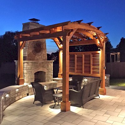 Arched Pergola Kit (Options: 12' L x 12' Arc W, California Redwood, No Electrical Wiring Trim, 4-Post Anchor Kit for Concrete, 1 Ceiling Fan Base, 1 Louver Privacy Panel, No Curtain Rods, Transparent Premium Sealant, 2 Posts Wrapped in Masonry, 8 x 8 Posts by Custom Request). Photo Courtesy of S. Hunter of Fort Smith, AR.