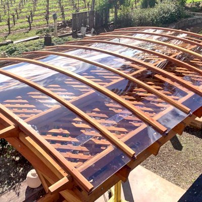 Arched Pergola Kit (Options: 14' L x 10' Arc W, California Redwood, with Rainguard, No Electrical Wiring Trim Kit, 4-Post Anchor Kit for Concrete, No Ceiling Fan Base, No Privacy Panels, No Curtain Rods, 10.5' Post Height, Transparent Premium Sealant). Photo Courtesy of S. Taplin of St. Helena, CA.