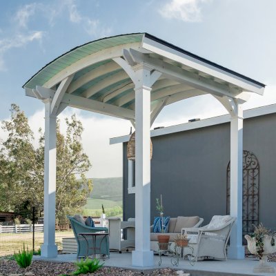  Arched Thick Timber Pavilion (Options: 12' L x 12' Arc W, Douglas-fir, 1 Electrical Wiring Trim, 4-Post Anchor Kit for Concrete, 1 Ceiling Fan Base, No Privacy Panel, No Curtain Rods, 12 ft H, Horizontal Decorative Trims on Posts, Custom Paint). Photo Courtesy of Siino Ventures of Kikrland, Washington.