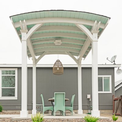  Arched Thick Timber Pavilion (Options: 12' L x 12' Arc W, Douglas-fir, 1 Electrical Wiring Trim, 4-Post Anchor Kit for Concrete, 1 Ceiling Fan Base, No Privacy Panel, No Curtain Rods, 12 ft H, Horizontal Decorative Trims on Posts, Custom Paint). Photo Courtesy of Siino Ventures of Kikrland, Washington.